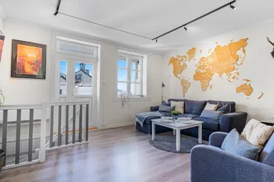 a living room with a couch and a table at Big central apartment w/ a view and parking in Bergen
