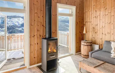a living room with a wood stove in a room at Stunning Home In Ålen in Ålen