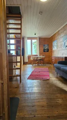 a living room with a table and a couch at Leilighet v Hardangerfjorden in Hesthamar