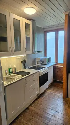 a kitchen with a sink and a stove at Leilighet v Hardangerfjorden in Hesthamar