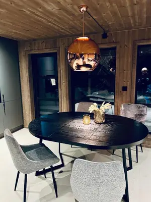 a dining room with a black table and chairs at Norebu - Norefjell in Noresund
