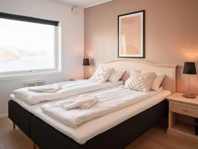 a large bed in a room with a window at Fjord Panorama in Stranda