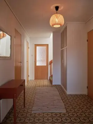 an empty hallway with a door and a room with a table at Fjord Panorama in Stranda