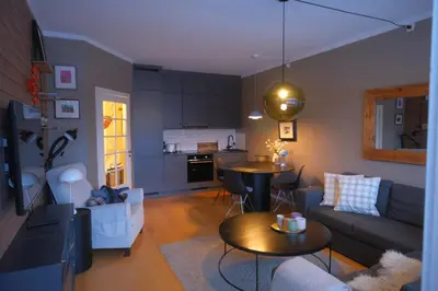 a living room with a couch and a table at Geilo sentrum for 4 personer in Geilo