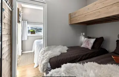 a bedroom with a bed and a large mirror at Geilo sentrum for 4 personer in Geilo
