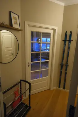 a room with skis on the wall next to a door at Geilo sentrum for 4 personer in Geilo