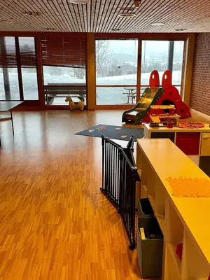 a room with a room with a table and a playground at Geilo sentrum for 4 personer in Geilo