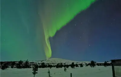 an aurora in the sky over a snow covered field at Gorgeous Apartment In Espedalen in Espedalen