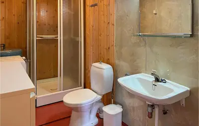 a bathroom with a toilet and a sink and a shower at Gorgeous Apartment In Espedalen in Espedalen
