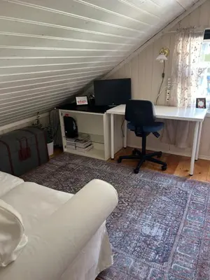 a bedroom with a desk and a bed and a desk and chair at Sandstad, Lilleby i Trondheim in Trondheim