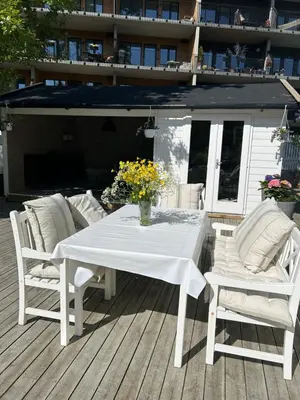 a white table and chairs on a deck at Sandstad, Lilleby i Trondheim in Trondheim