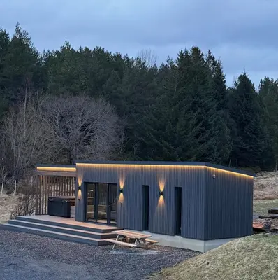 a small metal building with a picnic table in front at Nothaugen AS in Nordheim