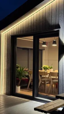 a room with a sliding glass door with a dining room at Nothaugen AS in Nordheim