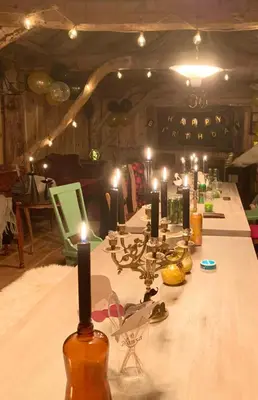 a long table with candles on it in a room at Secluded Holiday Home, With private beach in Ålesund